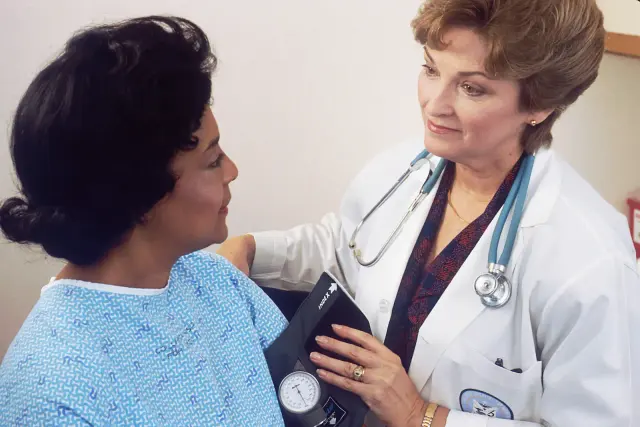 Anesthesia provider reviewing patient health history